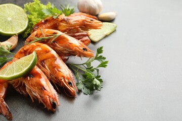 Tasty grilled shrimps with spices on grey table, space for text. Delicious seafood dish