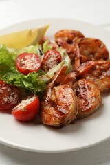 Tasty grilled shrimps with salad on white wooden table, closeup. Delicious seafood dish