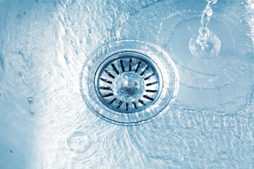 Water going down sink drain, closeup view