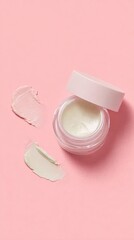 A close-up of a skincare cream jar with its lid slightly ajar, showcasing the product's texture against a soft pink background.