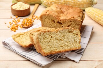 Freshly baked cornbread, cobs and seeds on wooden table, closeup