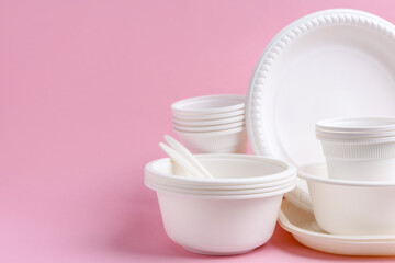 Set of disposable plastic tableware on pink background, closeup. Space for text