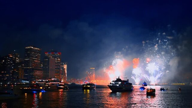 Spectacular firework show on the Independence Day celebration. Night celebration of 4th July in New York, USA. View from the river.