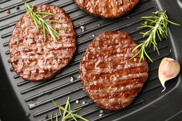 Pan with grilled patties and spices, top view