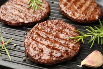 Pan with grilled patties and spices, closeup