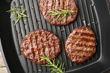 Pan with grilled patties and spices, top view