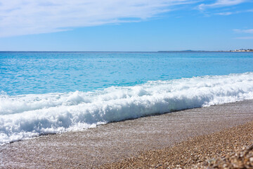 Beautiful view of wavy sea and pebbles on beach