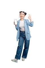 Full body Asian Woman in a blue blazer with smartphone, looking satisfied and making an OK gesture on PNG