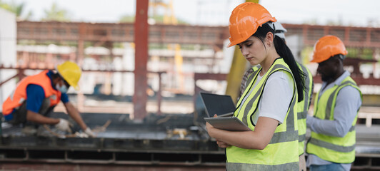 A group of engineers inspect the strength of the building and foundations, showing the...