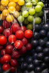 Fresh colorful grapes mix wrapped in transparent plastic packaging