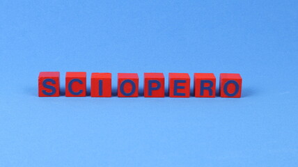 STRIKE written on red wooden cubes and a blue background.