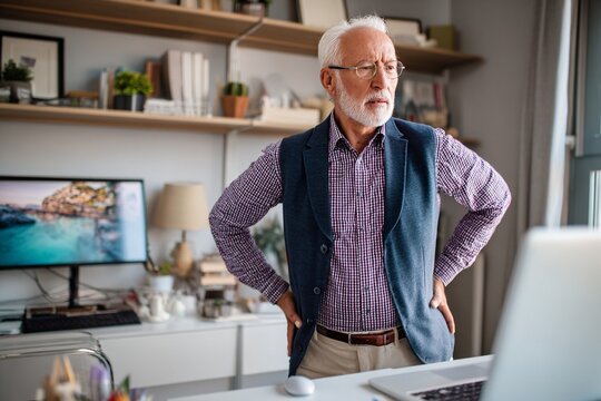 Concerned Senior Man Analyzing Computer Screen in Home Office Environment