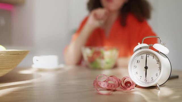 Woman eating fresh salad, practicing intermittent fasting with healthy nutrition