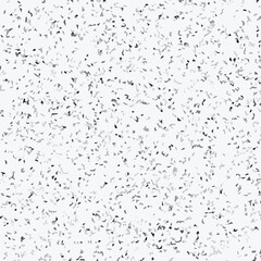 Abstract terrazzo seamless pattern with scattered stone chips in gray and black tones on white background texture.