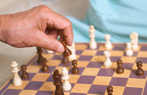 Hand making a chess move on a chess board during a strategic game
