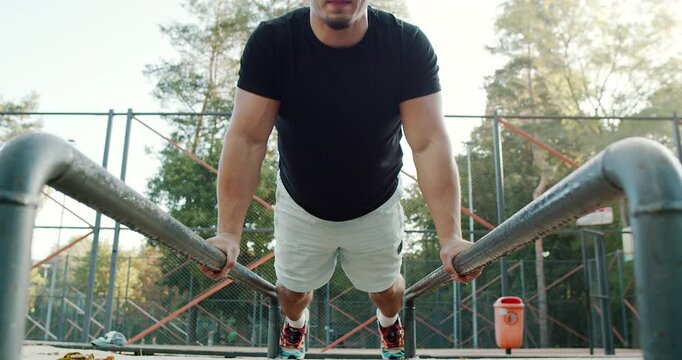 Engaging in the dynamic pushup exercise on parallel bars requires strength, balance, and technique