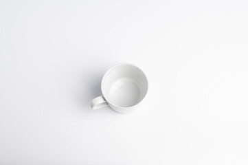 A simple white ceramic coffee mug on a clean white background