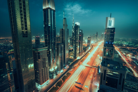 Aerial view of illuminated city skyline with skyscrapers along Sheikh Zayed Road a night, Dubai Media City, Dubai, UAE