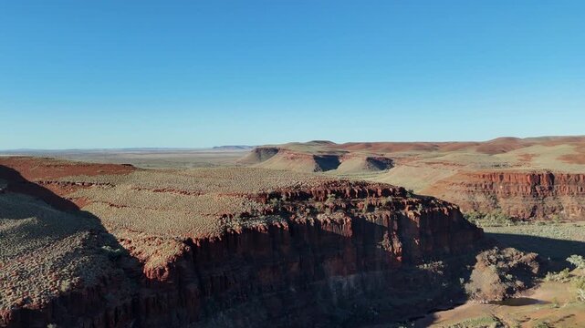 aerial drone shot of a remote bush camp along secluded George river in the beautiful red rolling hills of Millstream Chichester National Park, pilbara shire in West Australia.