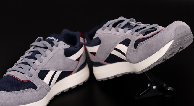 Nis, Serbia - 10 May 2025. Modern reebok classic canvas sneakers on a black background. Reebok GL 1000 unisex lifestyle sneakers. Running shoes. Close up.	
