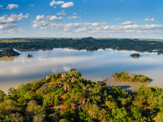 aerial view of scenic dam lake in africa, wilderness vegetation and blue sky