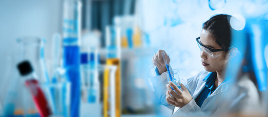 A woman in a lab coat is working with chemicals