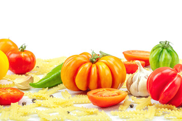 Raw mafalda corta pasta with assorted heirloom tomatoes, garlic, chili pepper, and spices