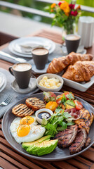 Gourmet breakfast platter featuring grilled steak, fried eggs, fresh vegetables, croissants, and coffee set on a sunny outdoor table