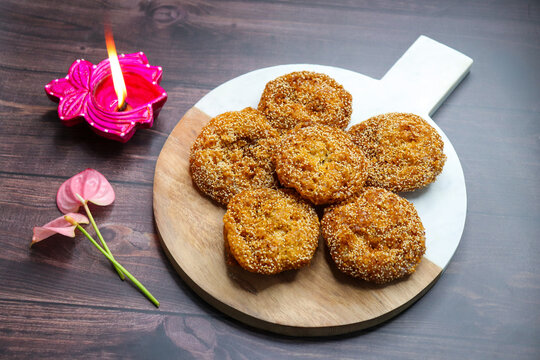 Anarsa is a popular Indian sweet made from rice, sugar, ghee, and poppy seeds. Traditionally part of Diwali Faral, Anarase is a crisp, rice based pastry enjoyed during the festive season. copy space.