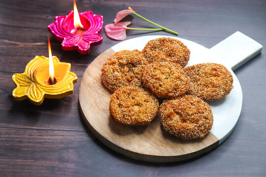 Anarsa is a popular Indian sweet made from rice, sugar, ghee, and poppy seeds. Traditionally part of Diwali Faral, Anarase is a crisp, rice based pastry enjoyed during the festive season. copy space.