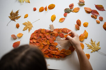 craft for kids. DIY autumn craft from leaves - home decor pumpkin for thanksgiving day. create art for children.