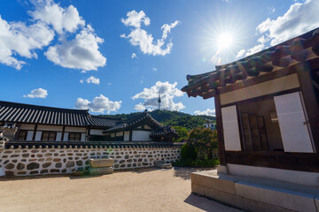 Fototapeta premium Namsangol Hanok Village and Seoul Tower Seoul's landmarks include a well and an ancient pavilion with a clear view of Seoul Tower.