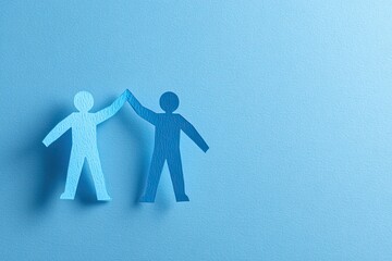 Two paper cutouts of people high-fiving on a light blue background