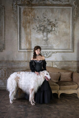 An elegant girl with a beautiful greyhound dog