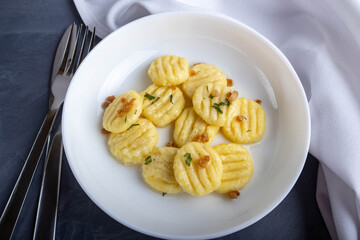 The prepared dish of potato gnocchi on a white plate