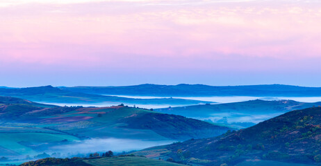 Obraz premium Aerial view with fog between the hills in the morning