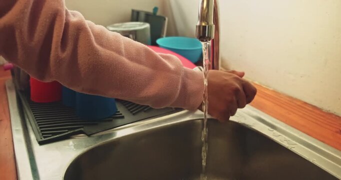 Washing hands in kitchen. High quality 4k footage