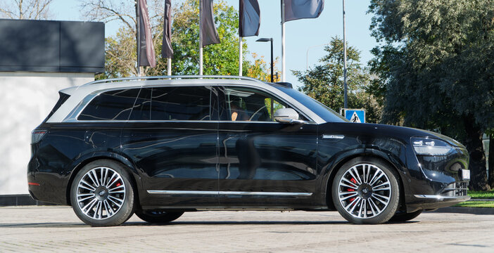 Black AITO Seres M9 is a premium hybrid SUV from Huawei IT company in the parking lot of the brand dealership. Black Huawei AITO Seres M9 EV SUV demonstration car.