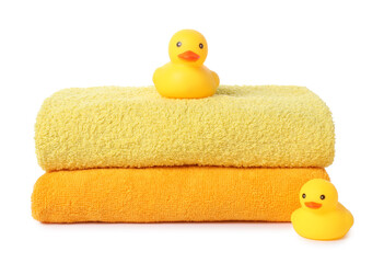 Stack of fresh terry towels and rubber ducks isolated on white