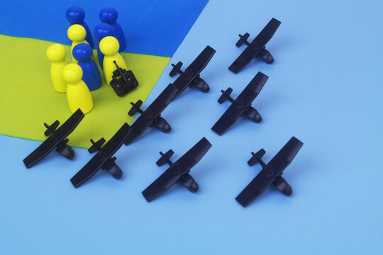 Many military drone models and flags of Ukraine with people figures. Drone war concept.