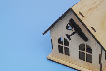 Close up of military drone hits house on blue background. Concept of drones attack houses.