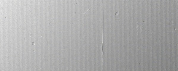 Close-up of textured gray cardboard, showing subtle fiber and surface irregularities, abstract, grainy, backdrop