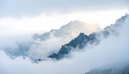 Mountain peaks emerge from a sea of ethereal white clouds in a hazy atmosphere