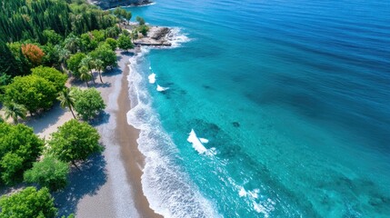 Aerial View of Tropical Island Coastline with Turquoise Water White Waves and Lush Green Vegetation on a Sunny Day Creating a Serene and Exotic Paradise