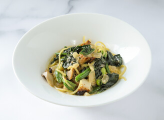 Teriyaki Chicken with Gorgonzola Cream Sauce Pasta, Spinach, and Mushrooms in bowl side view of japanese food