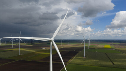 Wind turbines, clean energy and renewable energy. Beautifull crips blue sky and white clouds.