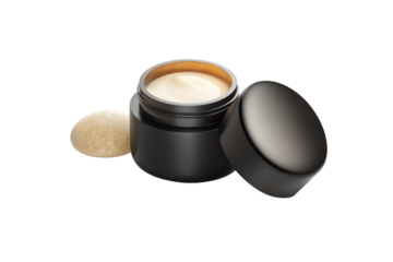 Luxurious cream in sleek black jar, accompanied by smooth stone, evokes sense of elegance and self care