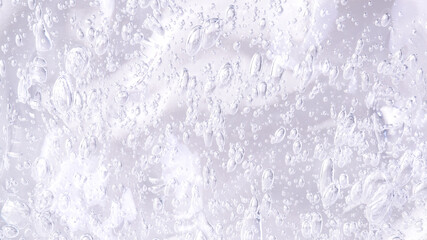 Fresh hydration concept: small bubbles in liquid, clean backdrop, 16:9.