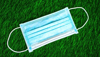 Medical Mask on Green Grass Background for Healthcare Concepts