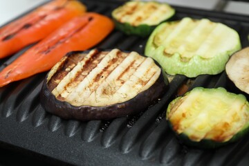 Electric grill with different tasty vegetables, closeup